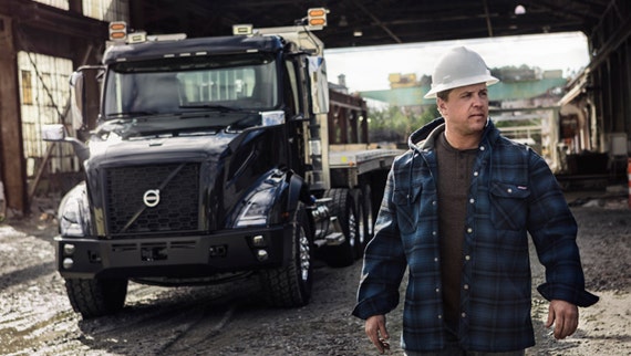 A Volvo truck parked in a warehouse.