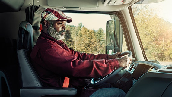A comfortable driver satisfied driving a Volvo.